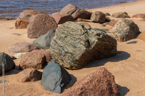 Nice landscape with boulders of different sizes by the sea on a sunny day. Latvia. The rocky coast of Vidzeme