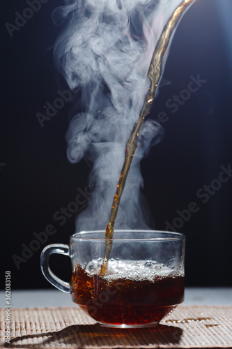 hot tea is poured into a mug