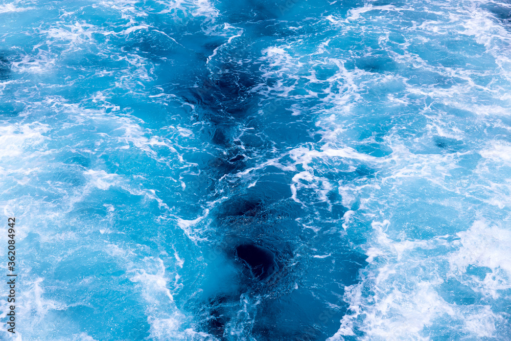 Speedboat tail on sea water photo. White foam on blue water. Ocean transportation. Tropical island hopping