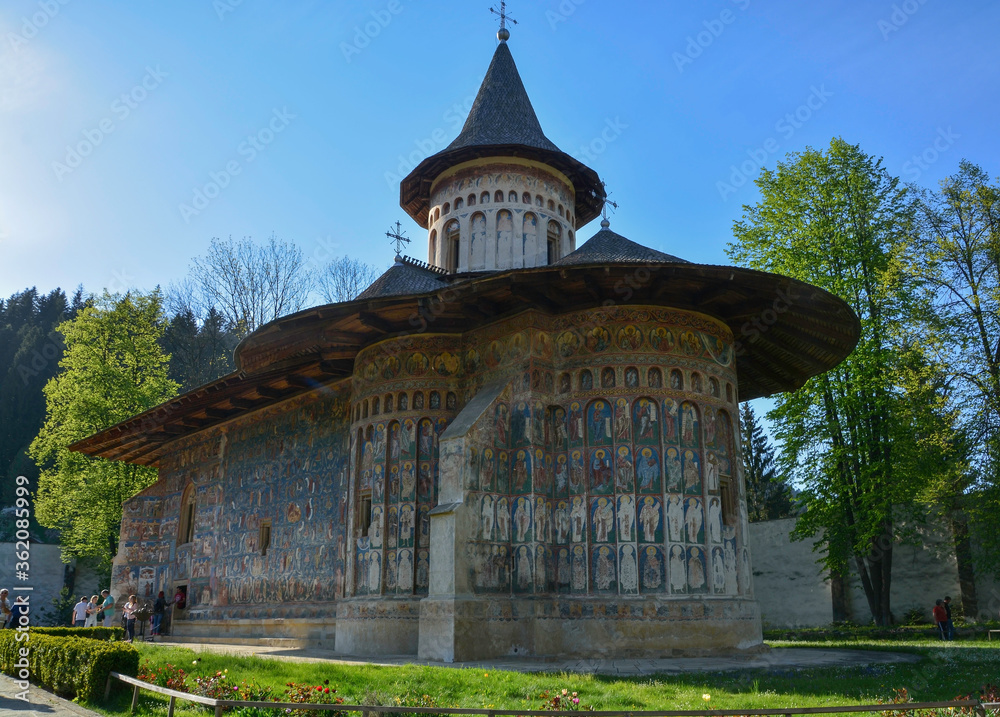VORONET MONASTERY, BUCOVINA, ROMANIA, EUROPE, SPRING 2018. Orthodox monastery. Moldovan architectural style. Outdoor paintings, frescoes and portraits of saints with Byzantine influence.