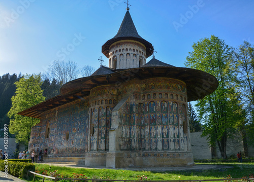 Obraz na płótnie VORONET MONASTERY, BUCOVINA, ROMANIA, EUROPE, SPRING 2018. Orthodox monastery. Moldovan architectural style. Outdoor paintings, frescoes and portraits of saints with Byzantine influence. w salonie