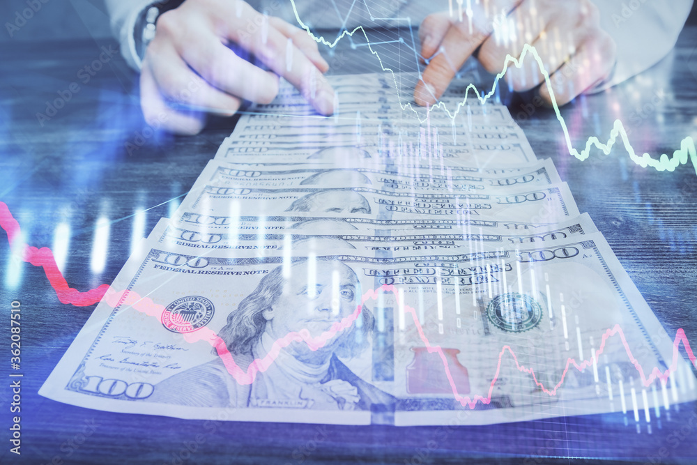 Multi exposure of forex graph drawing hologram and USA dollars bills and man hands. Technical Analysis concept. Multi exposure of forex graph drawing hologram and USA dollars bills and man hands. Technical Analysis concept.