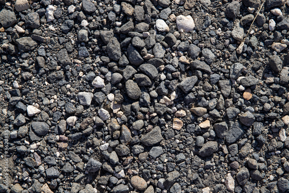 Grey gravel texture. Rustic road surface top view. Big gravel closeup photo for background. Rough gray stone road template Grey gravel texture. Rustic road surface top view. Big gravel closeup photo for background. Rough gray stone road template