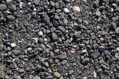 Grey gravel texture. Rustic road surface top view. Big gravel closeup photo for background. Rough gray stone road template