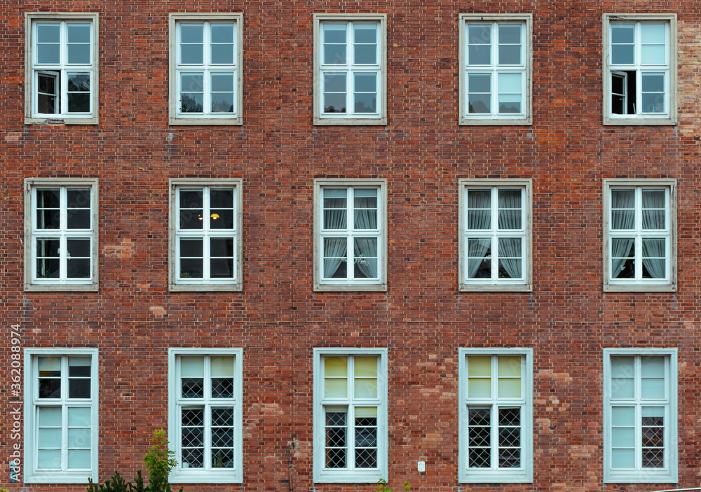 White window on a red brick wall