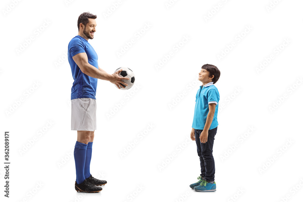 Footballer giving a soccer ball to a boy Footballer giving a soccer ball to a boy