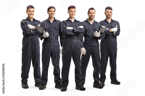 Team of five auto mechanic workers in uniforms