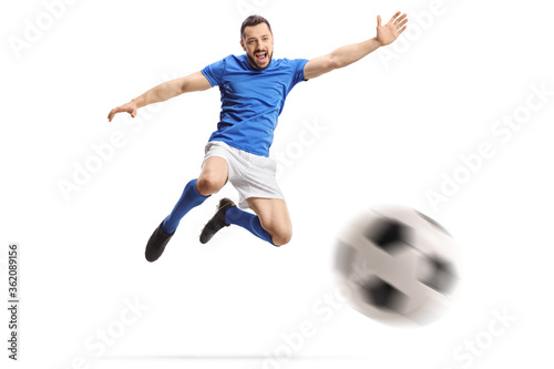 Footballer performing a volley with a soccer ball