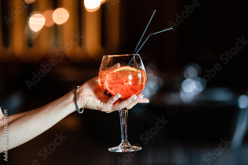 Aperol spritz in the hands of a girl. Aperol spritz. Cocktail.