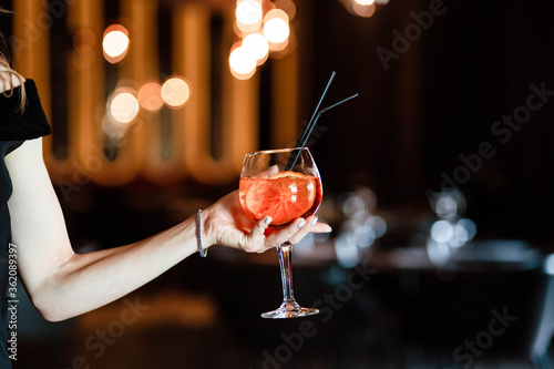 Aperol spritz in the hands of a girl. Aperol spritz. Cocktail.