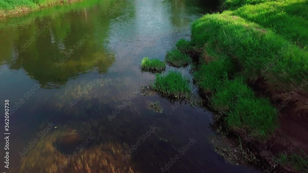 Flight over the River forest at sunset. Summer landscape of nature of Russia. Clear river water with bottom and algae. Moscow Region, Istra River. Fly drone Flight over the River forest at sunset. Summer landscape of nature of Russia. Clear river water with bottom and algae. Moscow Region, Istra River. Fly drone