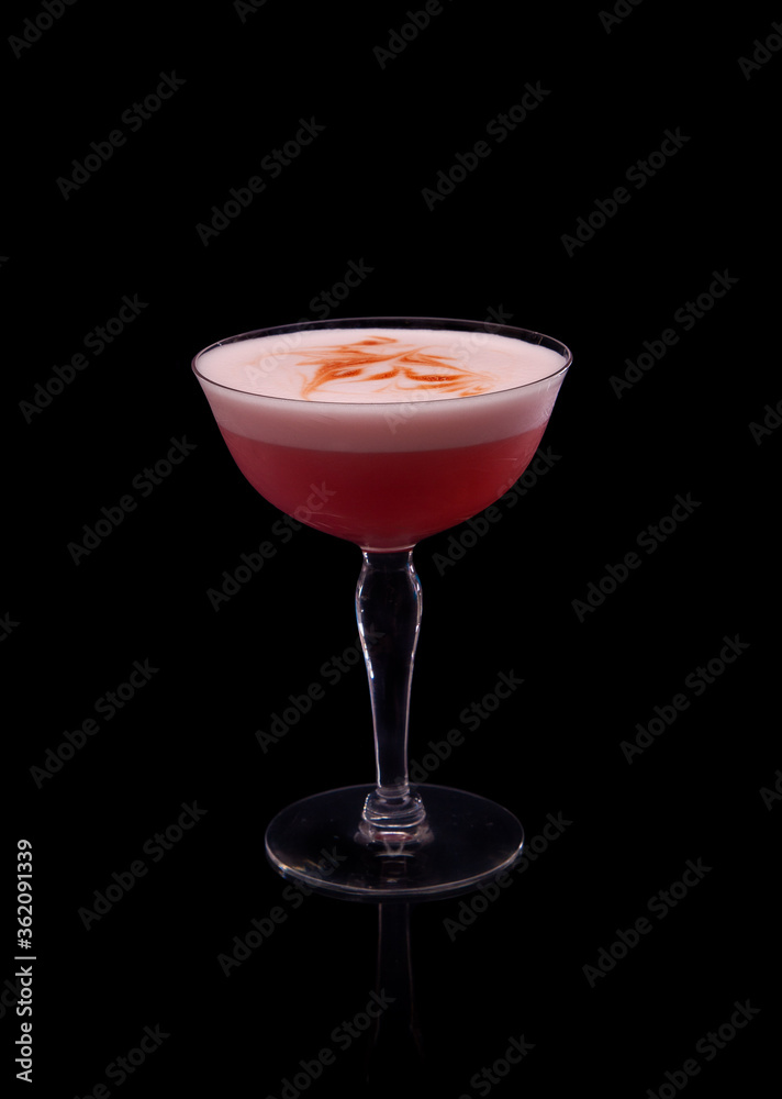 Gin Campari Sour, an egg white sour cocktail on a black background. Gin Campari Sour, an egg white sour cocktail on a black background.