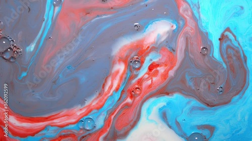 Abstract red white and blue background or wallpaper for screen, blue and red food coloring on a white plate with milk