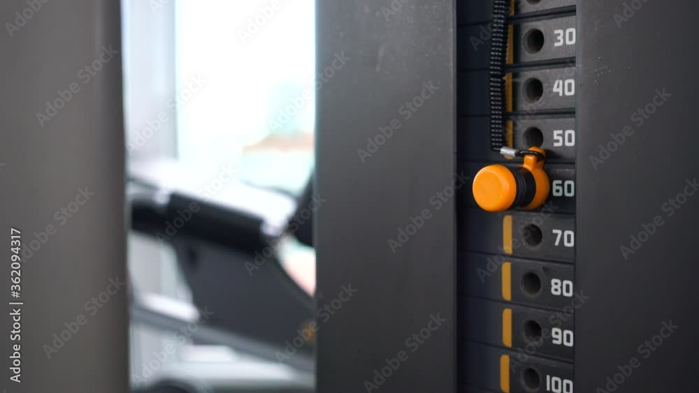 Weight machine with kilogram and pound numbers at fitness gym. Workout concept Weight machine with kilogram and pound numbers at fitness gym. Workout concept