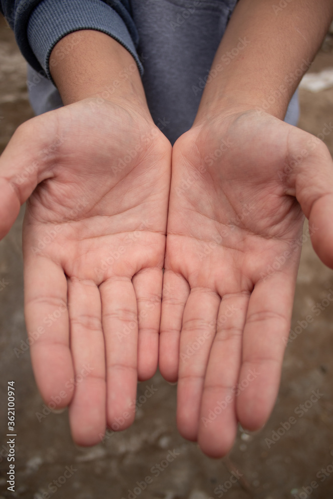 outstretched hands of a young person
outstretched hands of a young person
