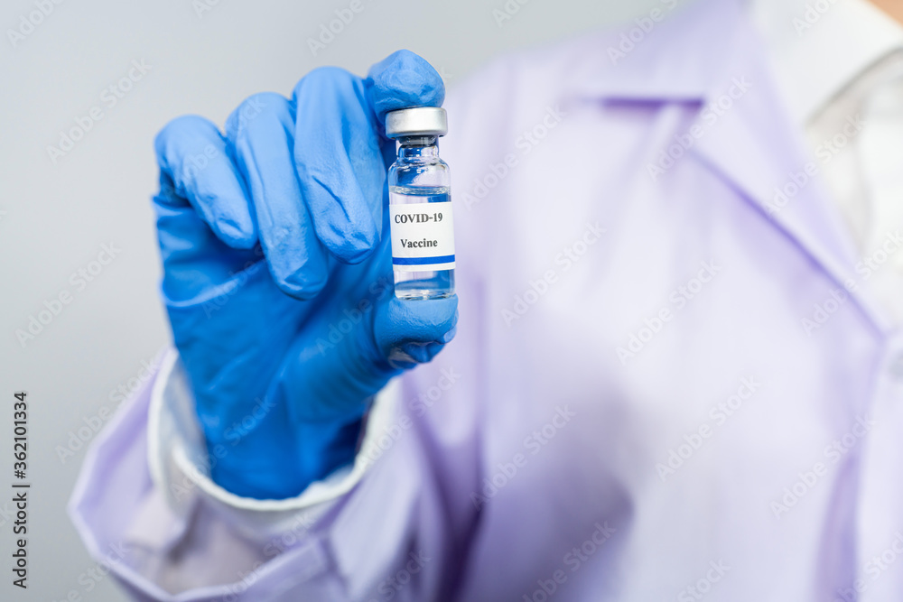 Doctor or scientist in protective suit with clinical injection trials covid-19 coronavirus vaccination Doctor or scientist in protective suit with clinical injection trials covid-19 coronavirus vaccination