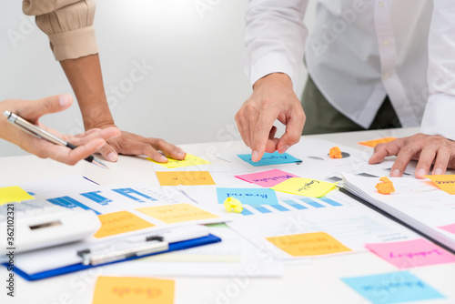 business team planning startup project placing sticky notes session to share idea or brainstorm