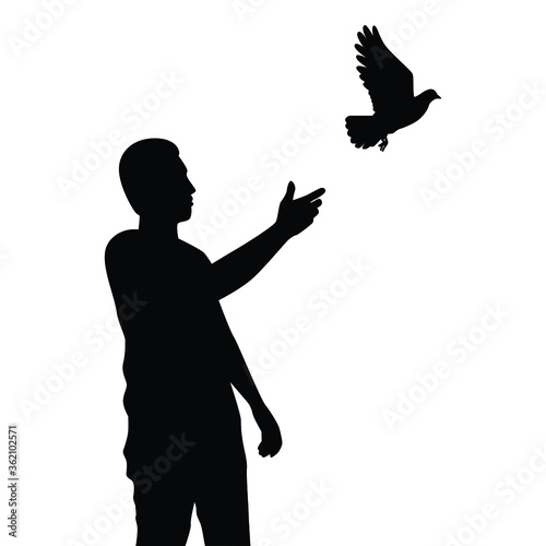 Young man releases a bird to freedom silhouette vector