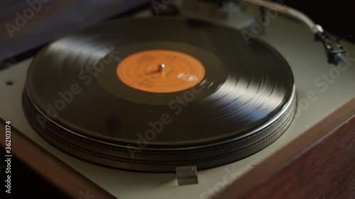 A vinyl record ends side A and gets flipped to side B