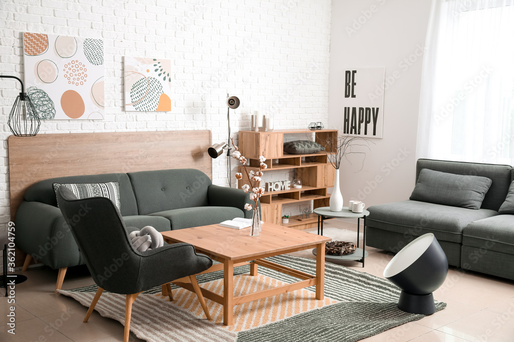 Stylish interior of living room with comfortable sofas and table