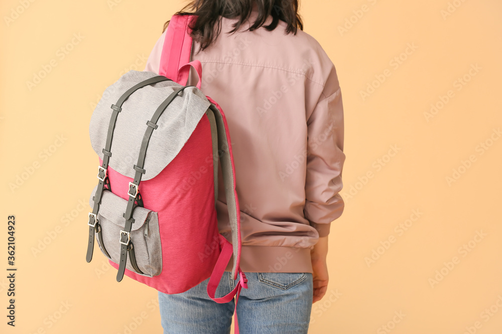 Young woman with backpack on color background Young woman with backpack on color background