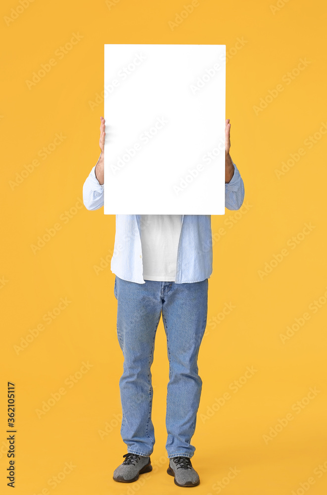 Young man with blank placard on color background Young man with blank placard on color background