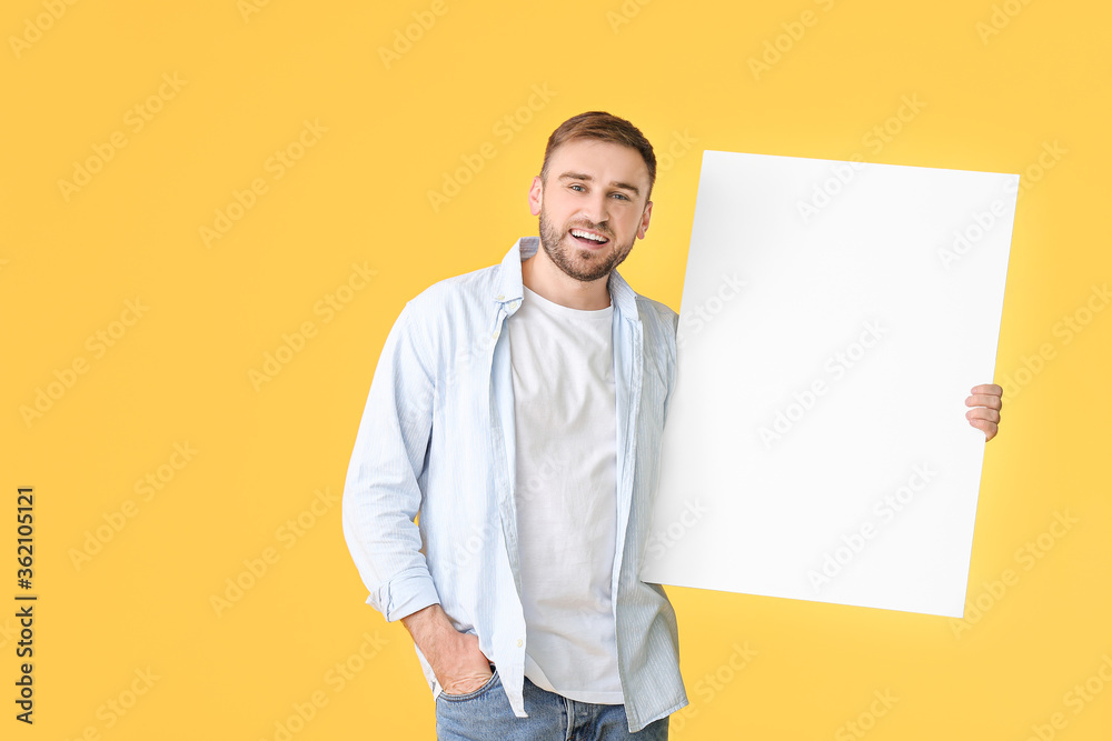 Young man with blank placard on color background Young man with blank placard on color background