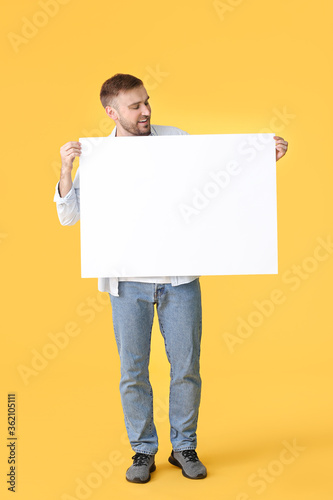 Young man with blank placar...
