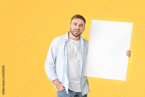 Young man with blank placar...