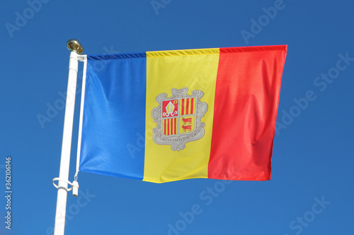 Flag of Andorra against the blue sky.