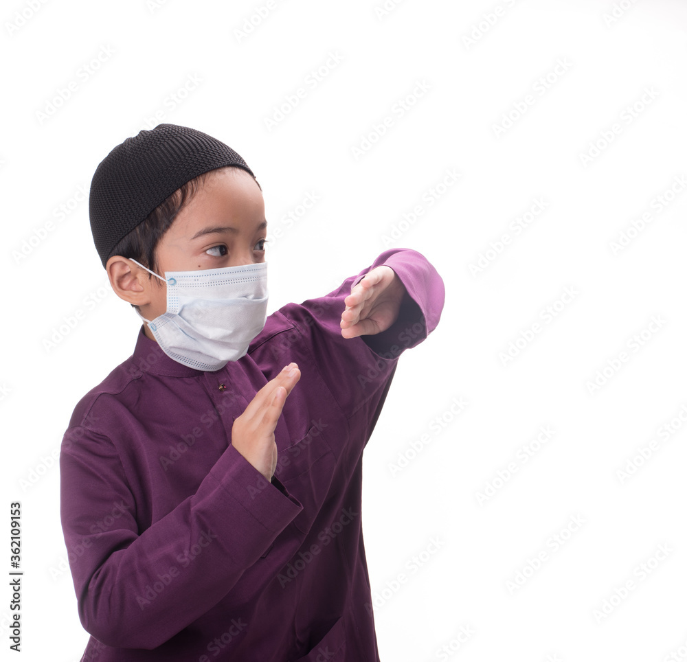 A Muslim kid with various poses isolated over white A Muslim kid with various poses isolated over white