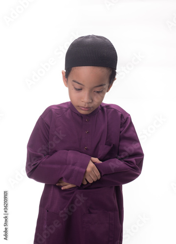A Muslim kid with various poses isolated over white