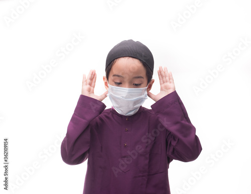 A Muslim kid with various poses isolated over white
