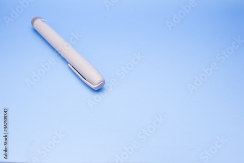 Insulin pen isolated over blue background