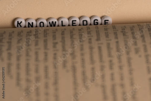 The word knowledge on a book,selective focus,dark background