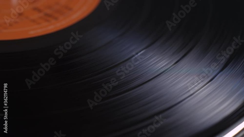 Close up of a vinyl music record spinning on a turntable playing music