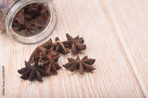 Star anise isolated over wooden background