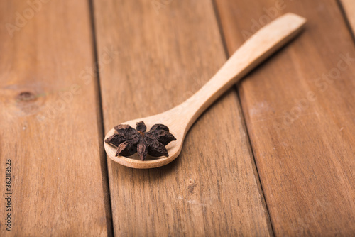 Star anise isolated over wooden background