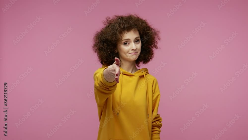 Nice to meet you! Friendly girl afro hairstyle in hoodie giving hand to handshake with partner, meeting new people getting acquainted, greeting partner. indoor studio shot isolated on pink background Nice to meet you! Friendly girl afro hairstyle in hoodie giving hand to handshake with partner, meeting new people getting acquainted, greeting partner. indoor studio shot isolated on pink background