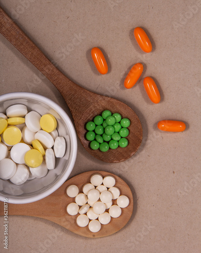 Pills and colored capsules out of the package. Color tablets and capsules from the wing view.