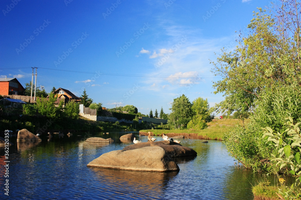 Stone boulders lie in the river