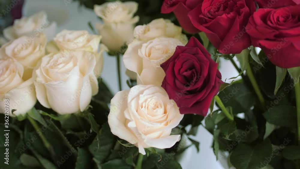 wine red white and pink rose flowers on floral shop display