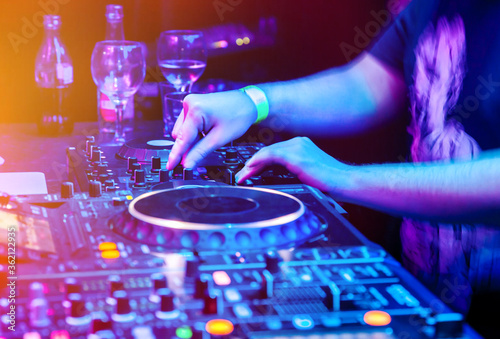 Dj mixes the track in nightclub at party. Body part on the DJ's music control panel