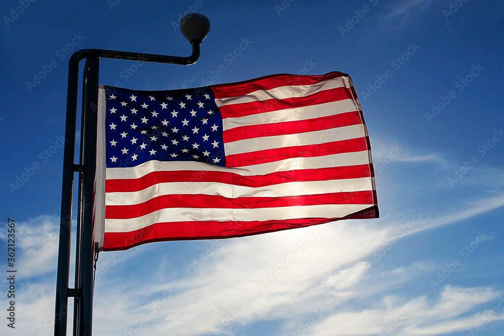 American flag against the sky at sunset evening American flag against the sky at sunset evening