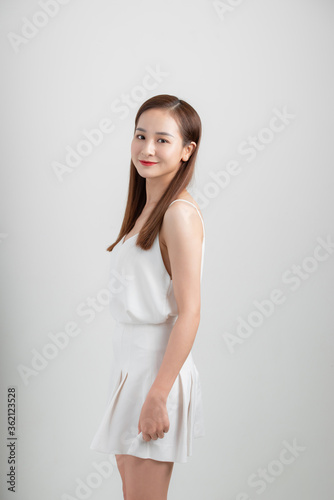 Portrait of an excited asian businesswoman jumping and looking at camera isolated over white background