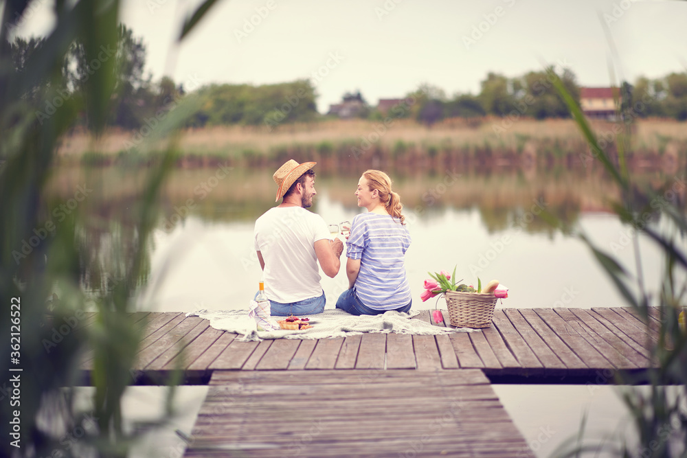 Back view on man and woman ho celebrating with wine at picnic. Back view on man and woman ho celebrating with wine at picnic.