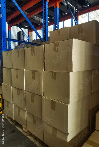 Shipment cartons box on pallets and wooden case on hand lift in interior warehouse cargo for export and sorting goods in freight logistics and transportation industrial