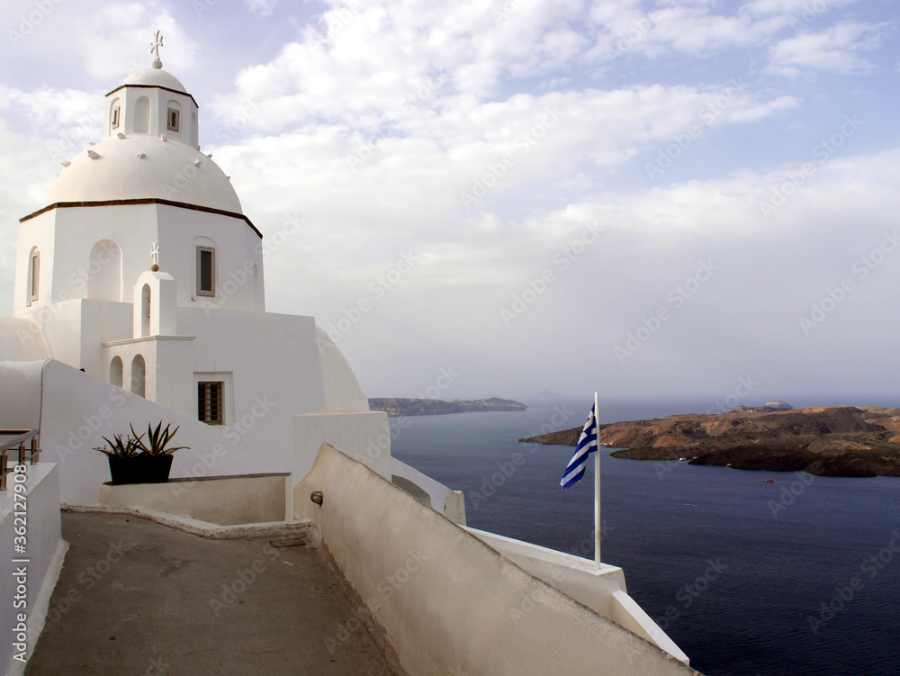 Typical urban landscape with a view of the church and the historical part of the town of Fira Santorini island, Greece.