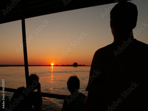  People silhouette sunset Chobe river cruise, Botswana