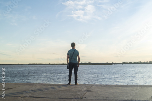 Lonely man looks at the water.